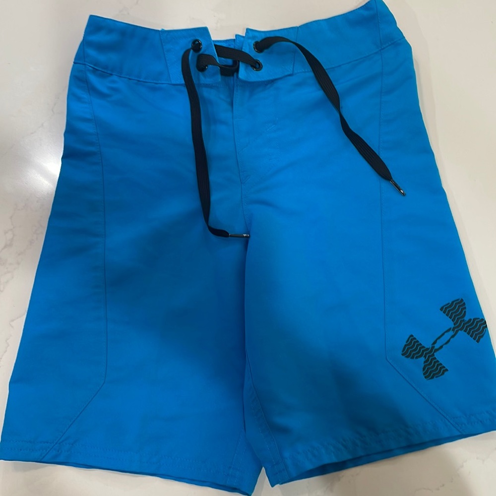 Boys blue Under Armour swim trunks. Size 24 loose.
